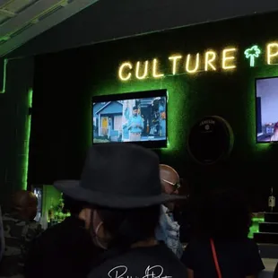 people watching televisions in a bar