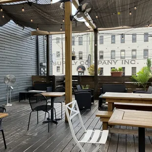 a patio with tables and chairs