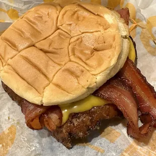 Butter burger with bacon, pickles, lettuce, and ketchup