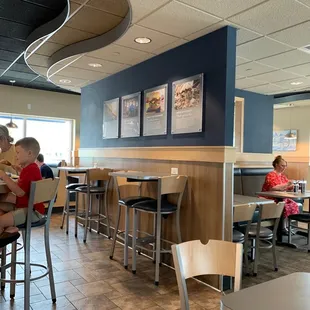 people sitting at tables in a restaurant
