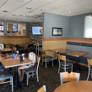 two people sitting at a table in a restaurant