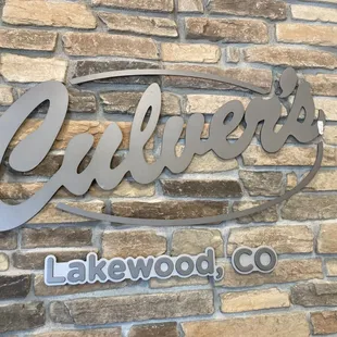 a close up of a sign on a brick wall