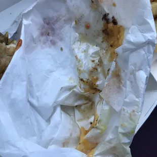 Greasy burger with 2 napkins for 2 meals