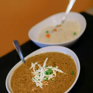 two bowls of soup on a table