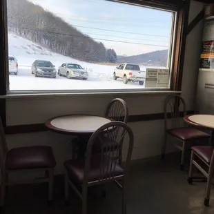 a table and chairs in front of a window