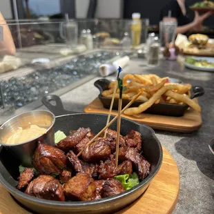 a plate of meat and fries