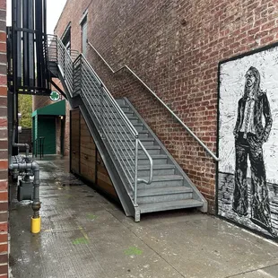 You have to enter in the alleyway where the green awning is