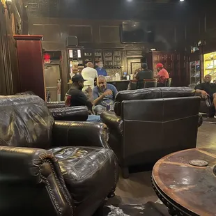 people sitting in leather chairs