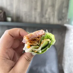 a hand holding a sandwich
