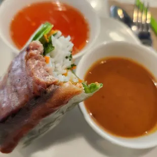 Nem Nuong (grilled meaballs) roll with fish and peanut sauces (2 rolls for $10)