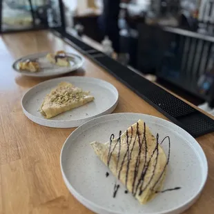 three plates of dessert on a counter