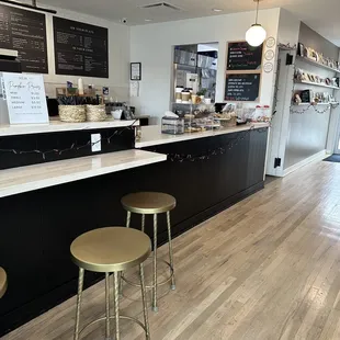 a coffee shop counter with stools