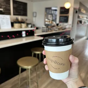 a person holding a cup of coffee