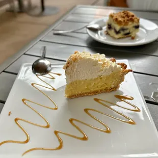 a piece of cake on a plate with caramel drizzle