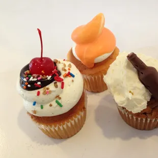 three cupcakes with different toppings