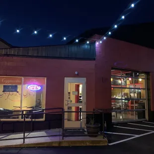 the outside of a coffee shop at night