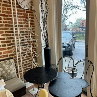 a table and chairs in front of a window