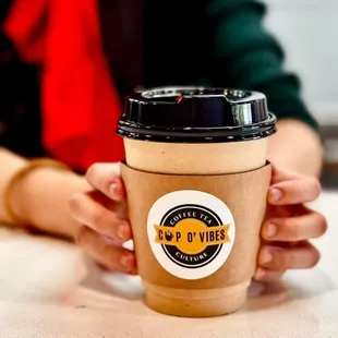  a person holding a cup of coffee