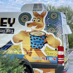 a cup of coffee on the back of a van