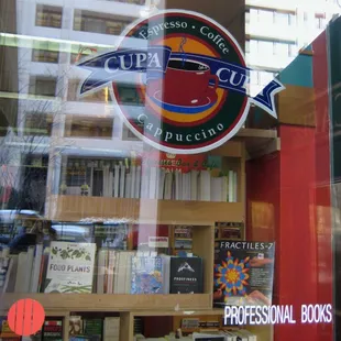 the reflection of a coffee shop window