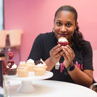 a woman eating a cupcake