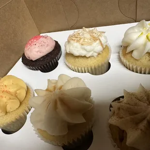 a variety of cupcakes in a box