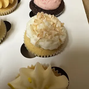 a variety of cupcakes in a box