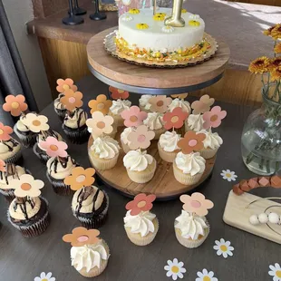 a cake and cupcakes on a table