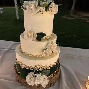 A  beautiful wedding cake.. 3 tier  Hunter Green , wedding colors, with gold leaf and florals from the bridal bouquet