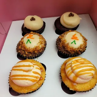 Pictured: 2 red velvet (back row), 2 carrot cake (center row), 2 salted caramel (front row) at Cupcakin' on 11/19/21.