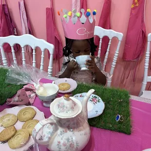 a little girl sitting at a table