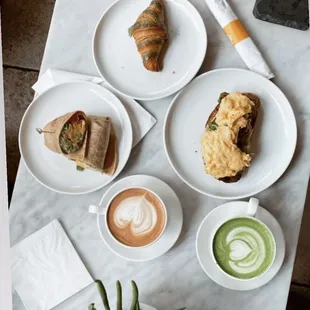 Clockwise: Pistachio croissant, Avocado toast with scrambled eggs, Matcha latte with oat milk, Nutella Latte and Avocado wrap!