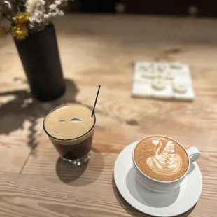 a cup of coffee on a wooden table