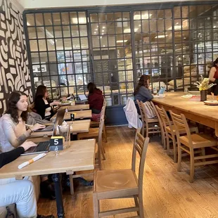 people sitting at tables in a restaurant