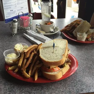 Balasco Burger with fries, in the background Veggie Wrap and fries.