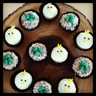 a plate of cupcakes decorated like birds