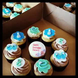 a box of cupcakes with frosting