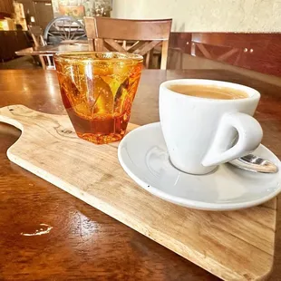 a cup of coffee and a spoon on a table