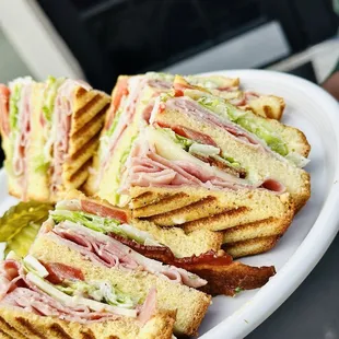 Club salmon. Bacon, turkey, ham, provolone cheese, house dressing, lettuce, tomatoe