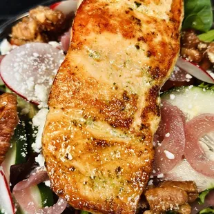 Grilled Salmon Garden salad with pickled onions, crunchy radish, candied peacans, cucumber, cherry tomatoes, and house made dressing