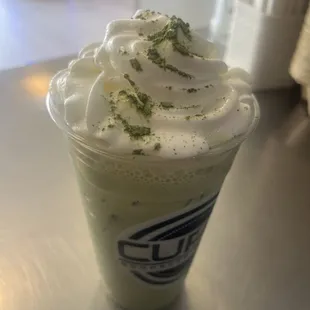 Matcha Spice Latte topped with Whipped Cream and Matcha Powder