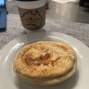 Beef and cheese meat pie with a latte