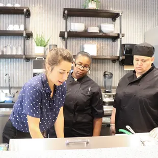 three chefs in a kitchen