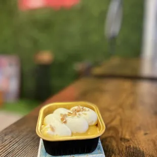 a bowl of ice cream on a wooden table