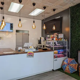 a coffee shop with a green wall
