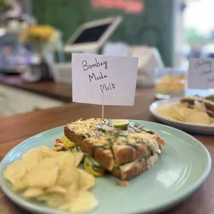 a plate with a sandwich and chips