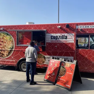 a man standing in front of a food truck