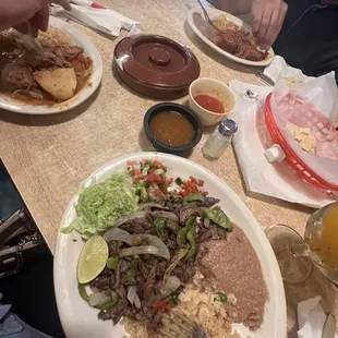 Fajita al carbón (right) Guiso de Rez (left) Guiso de puerco rojo (front)