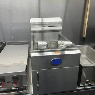 a commercial kitchen with stainless steel appliances