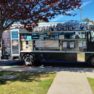 a food truck parked on the side of the road